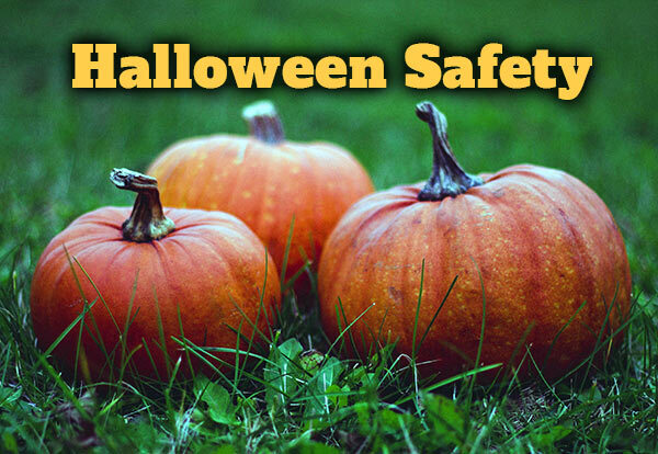 Three pumpkins on the ground with the text Halloween Safety.